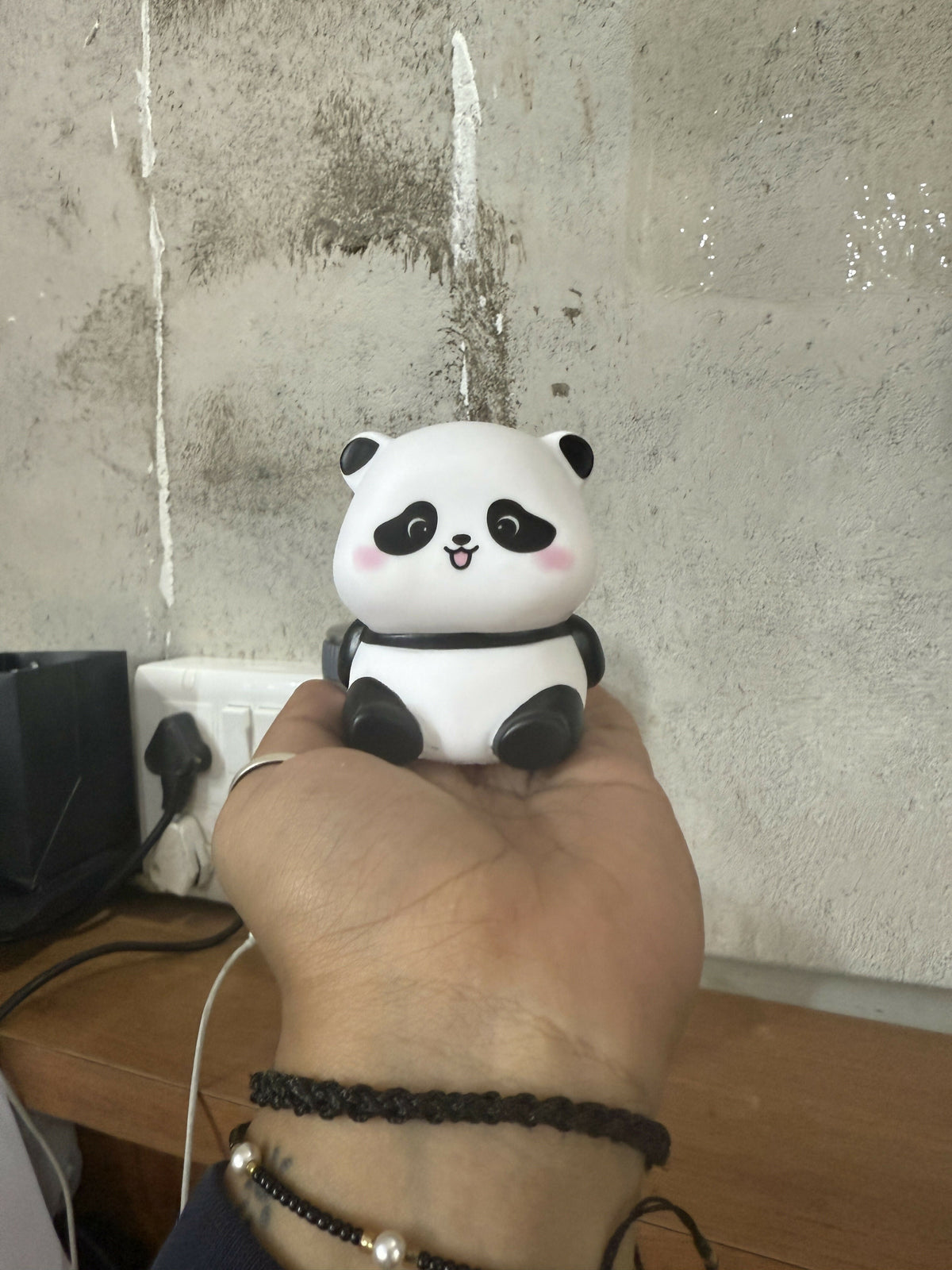 Side view of panda LED night lamp softly glowing in a kids' room