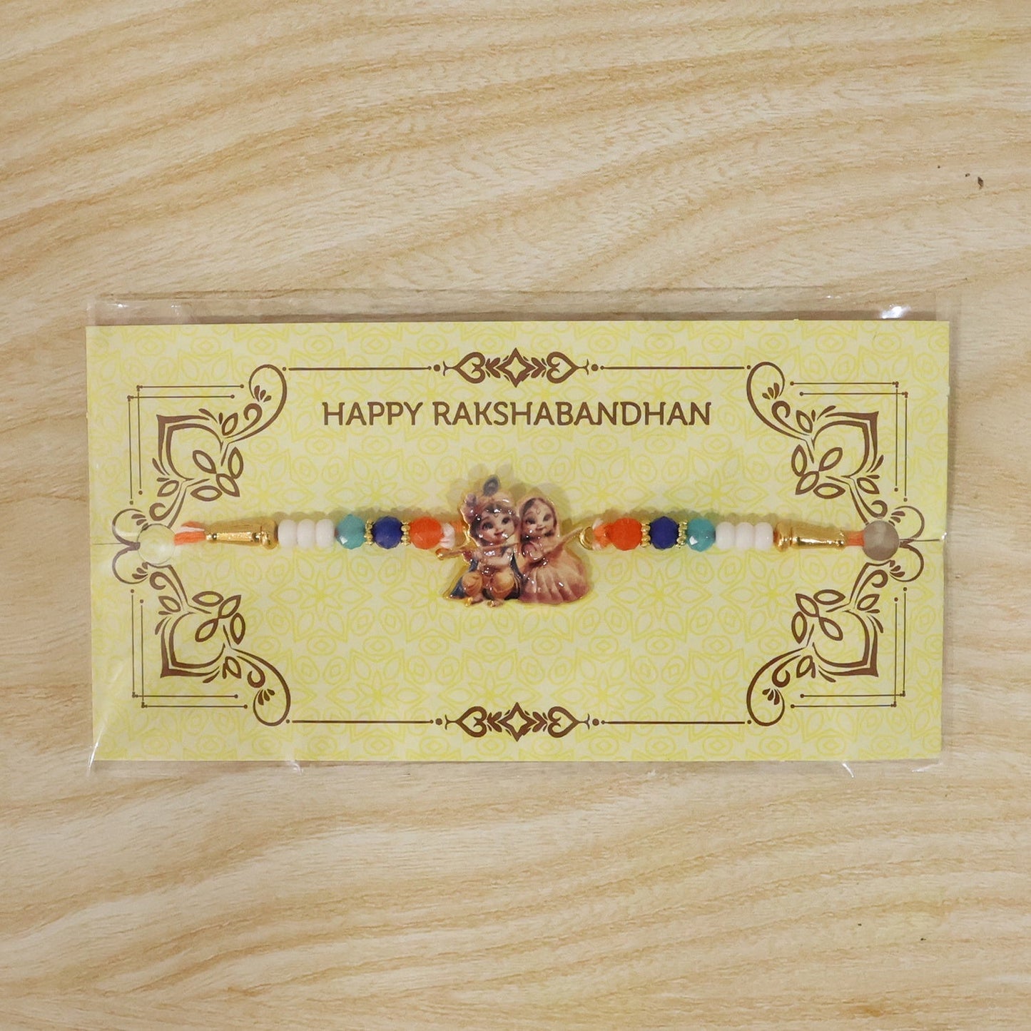 Decorative Radha Krishna Rakhi with intricate detailing, ideal for Raksha Bandhan.