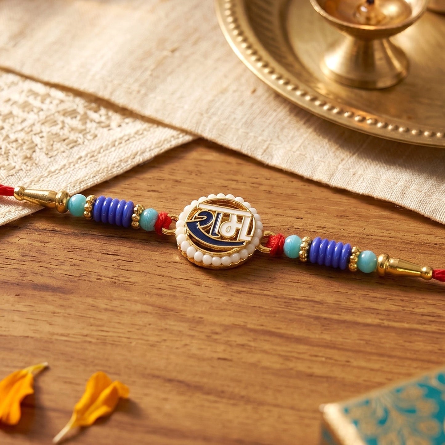 Traditional Rakhi thread tied around wrist with Ram Naam design and beads