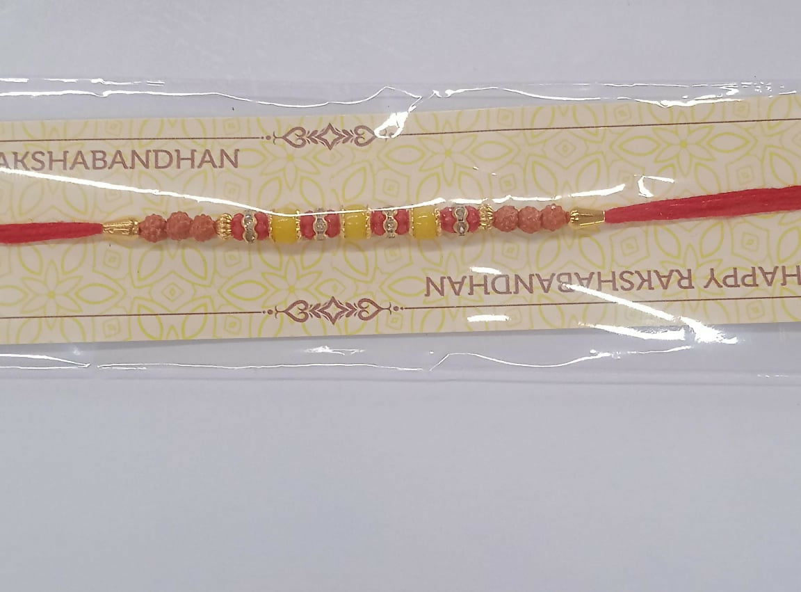 Intricate bead and stone detail on handcrafted multicolor festive rakhi for brother.