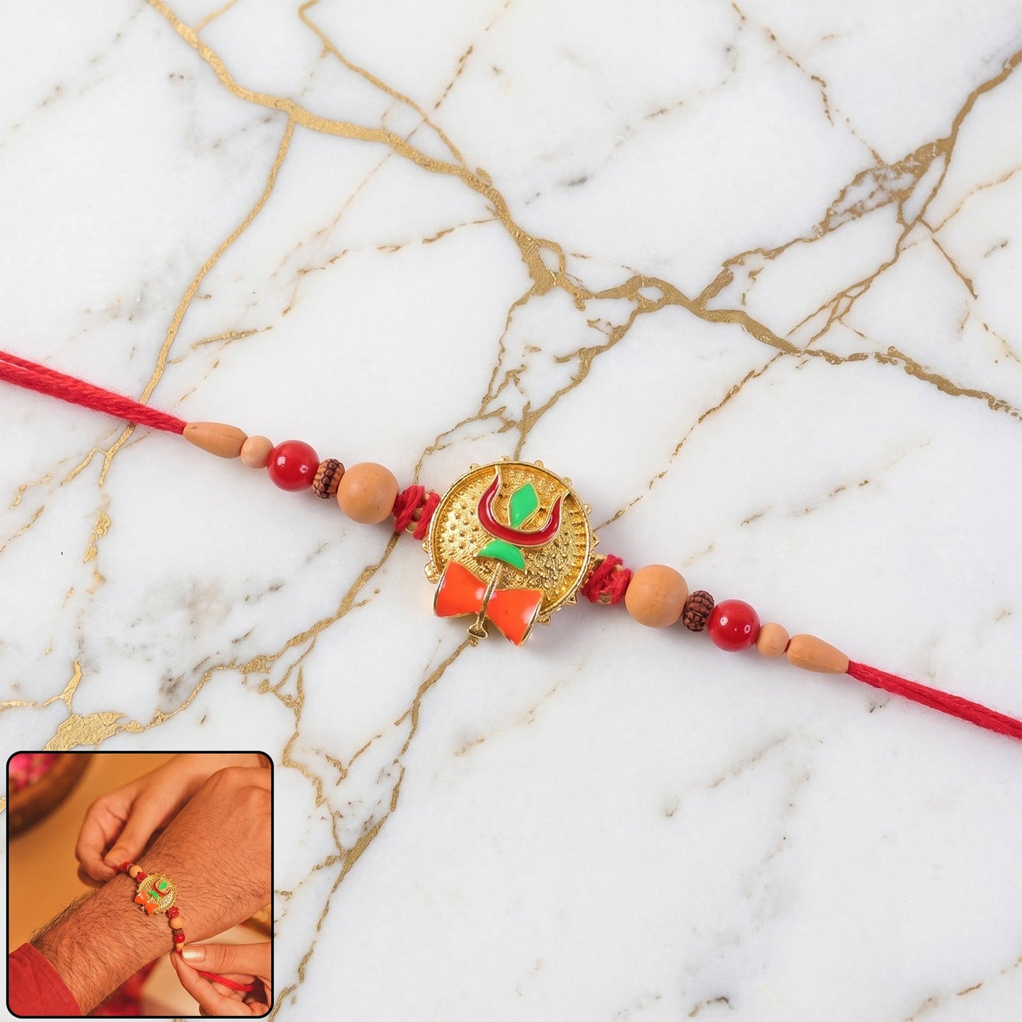 Trishul Damru Rakhi with peach beads on red thread, front view